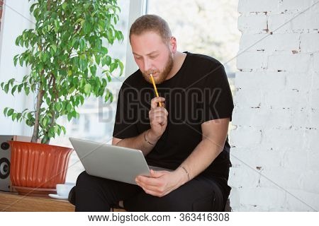 Young Man Studying At Home During Online Courses For Engineers, Doctors, Ecologists. Getting Profess