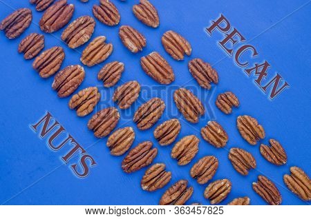 Pekan And Brazil Nuts On Blue Background. Healthy Food