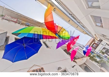 Colored Umbrellas In  Tiny Alley In Greece Island