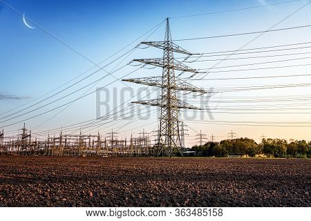 The Power Transmission Towers Of Sunset Sky Background . Electric Tower