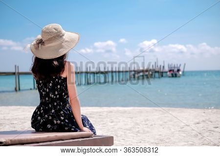 Asian Women Tourists Go To The Sea, Sit By The Sand, Beach With Beautiful Blue Sea Views Suitable Fo