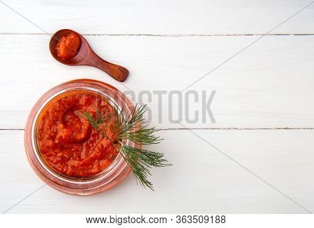 Balkan Snack Ajvar In A Jar On A White Background. Top View, Copy Space.