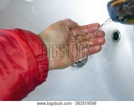 Close-up Shot Of A Hand Under Waer Running Of The Tap