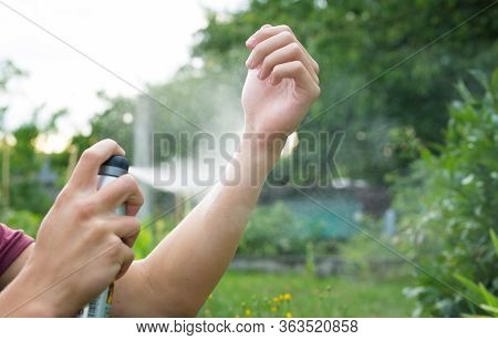Young Man Spraying Mosquito, Insect Repellent In The Forrest, Insect Protection, Helathcare Concept