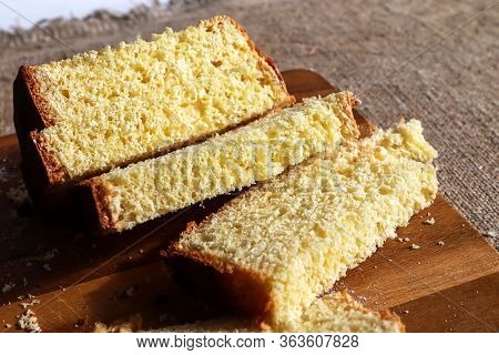 Homemade Wheat Cliced Bread On Wooden Cutting Board On Burlap Background. Bake Pies At Home