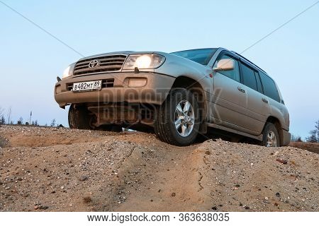 Novyy Urengoy, Russia - April 28, 2020: Offroad Car Toyota Land Cruiser 100 In The Sand And Stone De