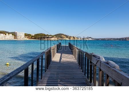 Wooden Jetty In Mediterranean Sea At Son Matias, Mallorca During Sunset, Spain