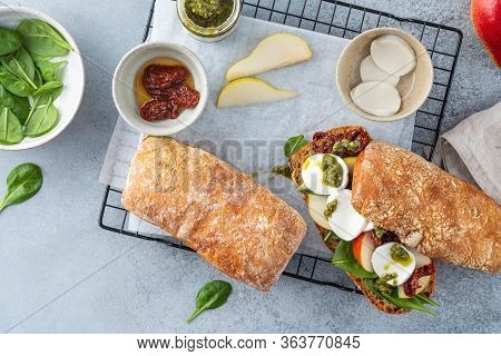 Sandwich With Sun Dried Tomatoes, Mozzarella And Basil Pesto. Copy Space.