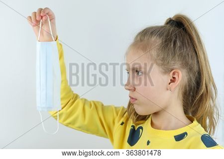 Beautiful Girl, Child In Yellow T-shirt On The White Background Takes Off Medical Helthcare Guarding
