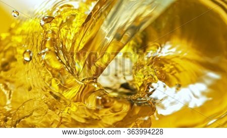 Freeze Motion Shot of Splashing White Wine on Golden Background