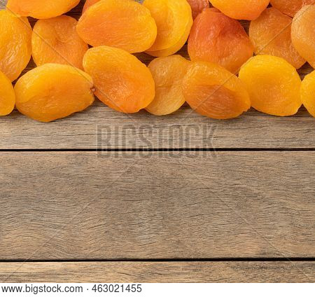 Dried Apricots Over Wooden Table With Copy Space.