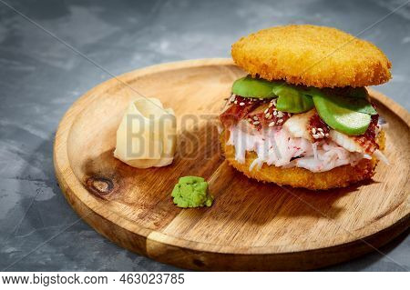 Pan-asian Cuisine Concept. Japanese Sushi Burger Made From Rice Bread, Crab Meat, Avokado And Wasabi