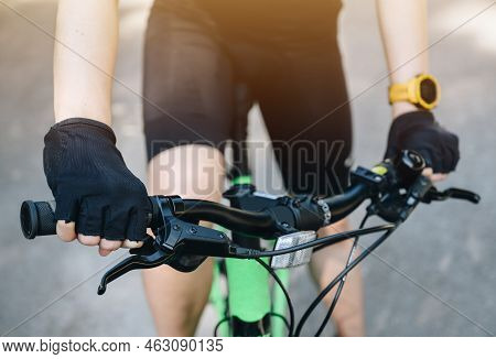 Cropped Shot Of Cyclist Hands Wearing Glove And Holding A Handlebars For Control A Bike. A Bicycle H