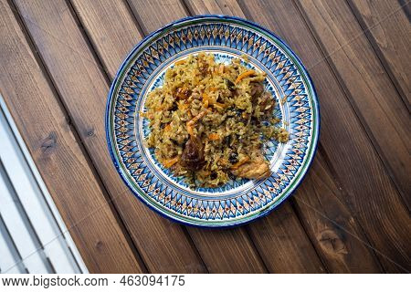 Pilaf On A Plate. Uzbek National Painting Rishtan. National Oriental Cuisine.