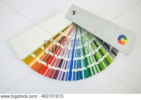 Color Guide Close Up. Assortment Of Colors For Design. Colors Palette Fan On White Concrete Wall Bac