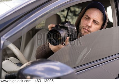 Private Detective With Camera Spying From Car, Taking Photo With Professional Camera