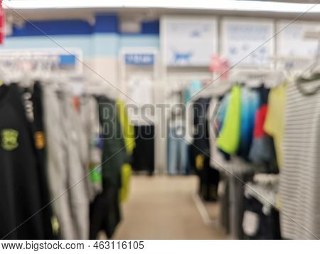 Blurred Children Clothing Store With Discount Sign And Variety Of Clothes For Newborn, Kids, Toddler
