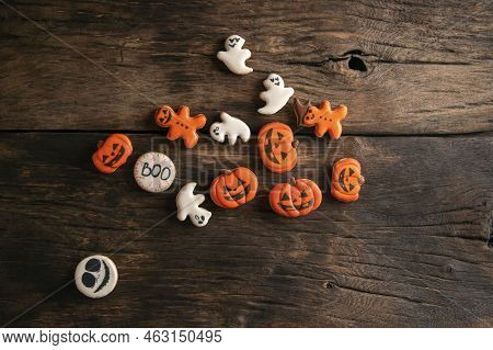 Halloween Gingerbread Cookies On Wooden Planks. Halloween Pumpkin, Ghosts And Gingerman. Top View