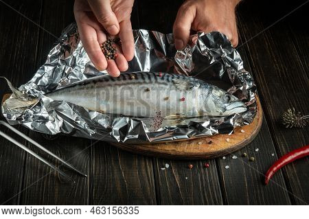 Close-up Of Chef Hands While Preparing Delicious Scomber Or Mackerel. Delicious Recipe For Baking Fi