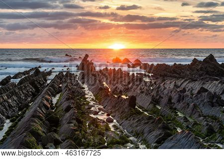 Stunning Sunset Landscape Image Of Welcome Mouth Beach In Devon England With Beautiful Rock Formatio