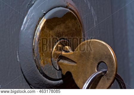 The Key In The Bolt Lock (latch Type). Key And Lock In Golden Color. The Lock Set In The Door Is Pai