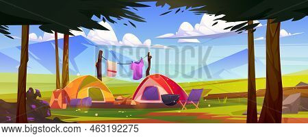 Tourist Camp At Nature Landscape With Trees And Mountains. Camping Tents With Traveler Drying Clothe