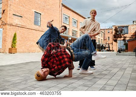 Full Length Shot Of All Male Breakdance Team Posing Outdoors In City Setting