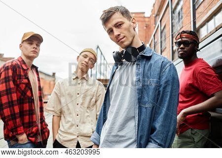 Diverse Group Of Young Men Wearing Streetstyle And Looking At Camera Outdoors, All Male Team