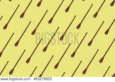 Top View On Many Bamboo Spoons On A Yellow Background, Eco Tableware, Disposable Cutlery, Wood Biode