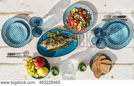 Gilt-head Bream Also Known As Orata Baked In The Oven And Served On A White Wooden Table With Vegeta