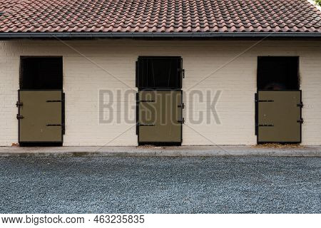 Denderwindeke, Ninove, East Flemish Region - Belgium - 07 14 2021 Horse Stables Facade In Brown Colo