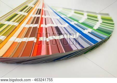 Color Guide Close Up. Assortment Of Colors For Design. Colors Palette Fan On White Concrete Wall Bac