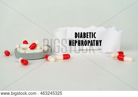 Medical Concept. On A Gray Background, Medical Capsules And A Paper Plate With The Inscription - Dia