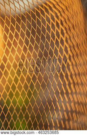 Closeup Photo, Abstract Background, Metallic Structure Net. Warm Orange Color Flexible Bend Abstract