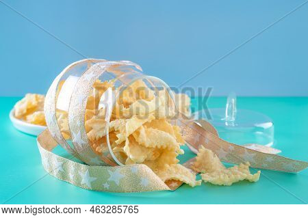 Sfrappole Or Chiachiere Or Angel Wings On A Bright Blue Background. Italian Carnival And Typical Foo