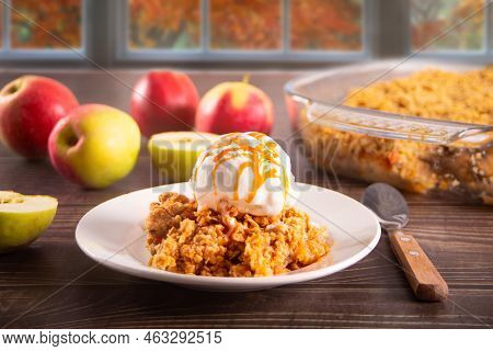 Homemade Apple Cramble Crisp Cake On White Plate With Autumn Leaves On The Background.
