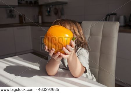 Child Holding Yellow Paprika.  Healthy Food Concept.  Child Nutrition. Fresh Vegetables In The Hands