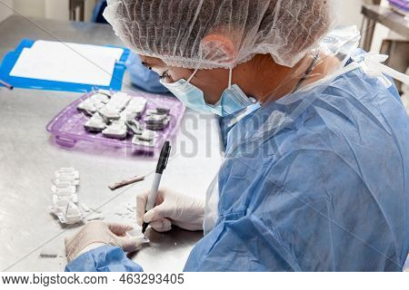 Scientist Preparing Paraffin Blocks Containing Biopsy Tissue For Sectioning. Pathology Laboratory. C