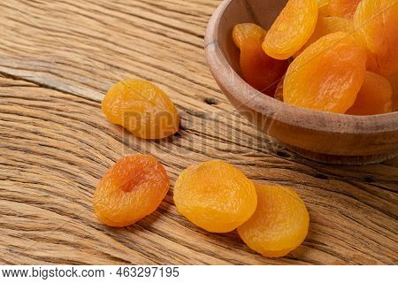 Dried Apricots On A Bowl Over Wooden Table.