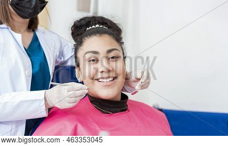 Dentist Doctor Examining Mouth To Female Patient Looking At Camera Lying On Chair, Female Dentist Wi