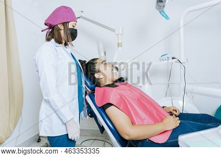 Intraoral Radiography Concept. Dentist Doing Intraoral Dental X-ray To Patient, Side View Of Dentist