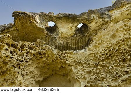 Top Of The Cliff In The Form Of A Smiling Face With Eyes And A Mouth. Texture, Weathered Limestone B