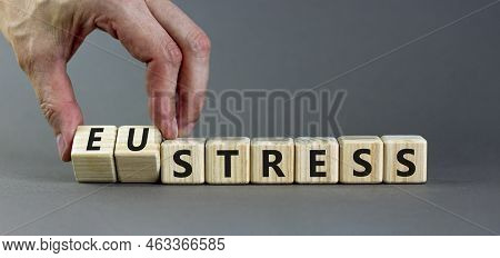 Eustress Or Stress Symbol. Psychologist Turns Cubes And Changes The Concept Word Eustress To Stress.