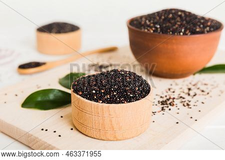 Quinoa Seeds In Bowl And Spoon On Colored Background. Healthy Kinwa In Small Bowl. Healthy Superfood