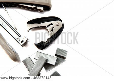 Stapler And Anti-stapler With Staples On A White Background. Office Supplies Isolate