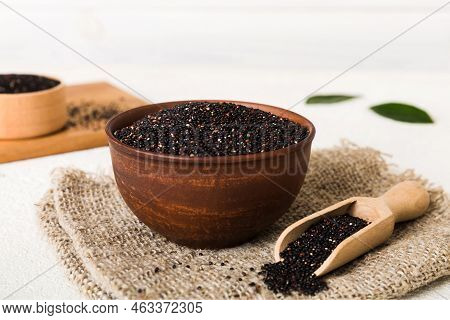 Quinoa Seeds In Bowl And Spoon On Colored Background. Healthy Kinwa In Small Bowl. Healthy Superfood