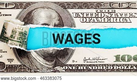 Wages Word Written On With American Dollar-bills. Salary And Wages Concept. The Word Wages On Dollar