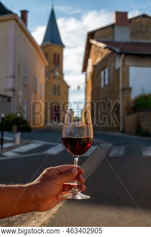 Tasting Of Red Wine By Old Wine Maker In Pierres Dorées Region With Yellow Stone Houses On South Of