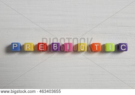 Word Prebiotic Made Of Colorful Cubes On Wooden Table, Flat Lay