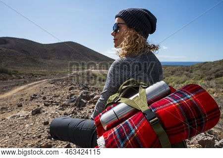 Happy Traveler With Backpack And Bottle Of Water Sitting On Ground At Mountain And Enjoying Valley V
